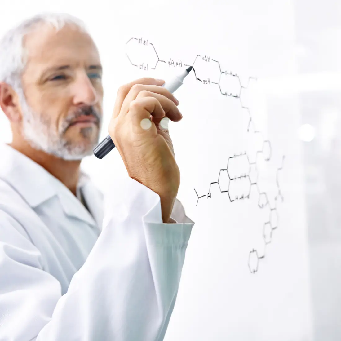 A Natuas Labs formulation scientist reviewing a compound structure